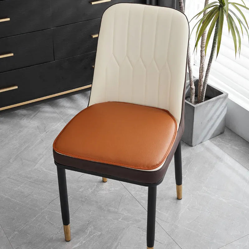 Leather horseshoe-shaped non-slip seat cushion on a chair, shown in beige colour.
