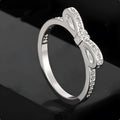 Silver-coloured fashion ring with a bow design adorned with clear zircon crystal stones.