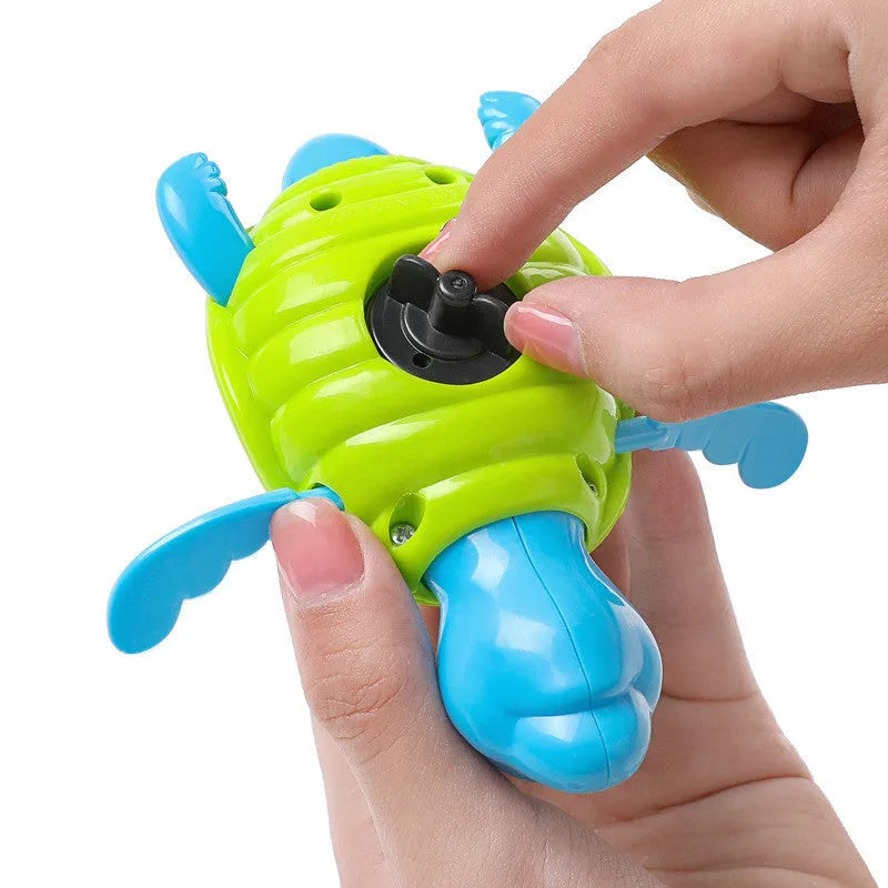 Plastic baby tortoise bath toy floating in water for bath time play