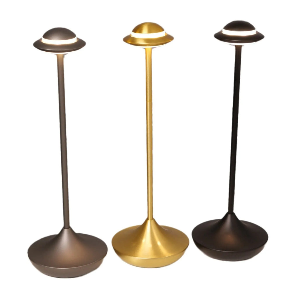 Metallic UFO-shaped rechargeable desk lamp with touch base in black, gold, or grey colour.