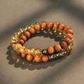 Handcrafted Barbie tan yellow tower crystal double ring bracelet on wrist.