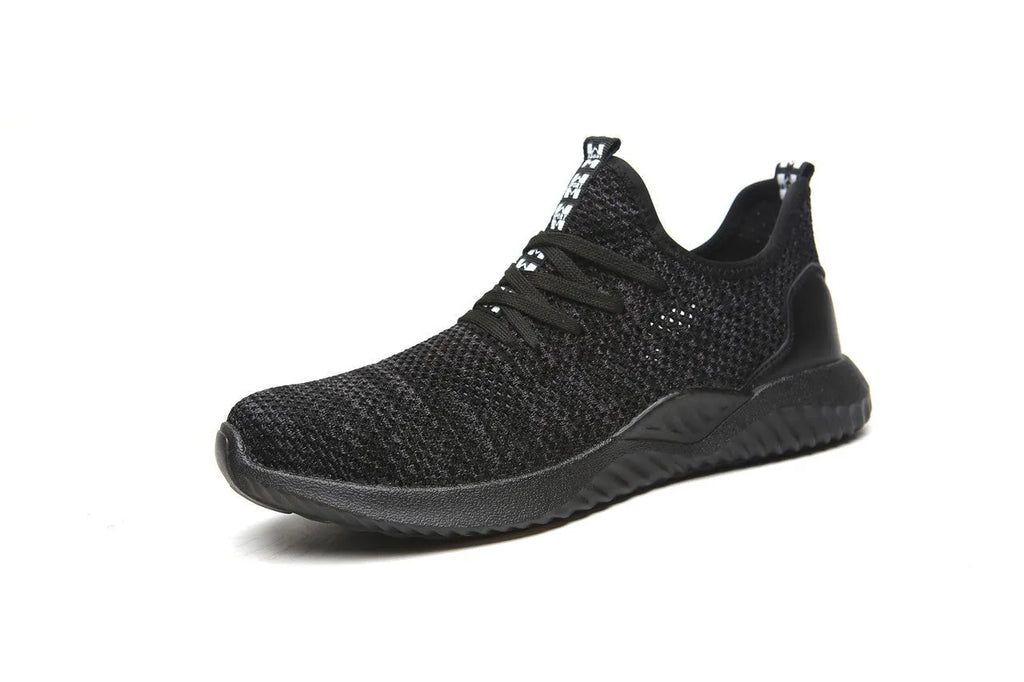 Low-cut black safety shoe with a steel toe cap on a grey background.