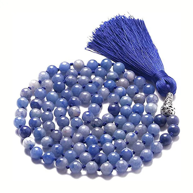 Long blue gemstone tassel necklace with agate, lapis lazuli, and turquoise beads on a geometric pendant.