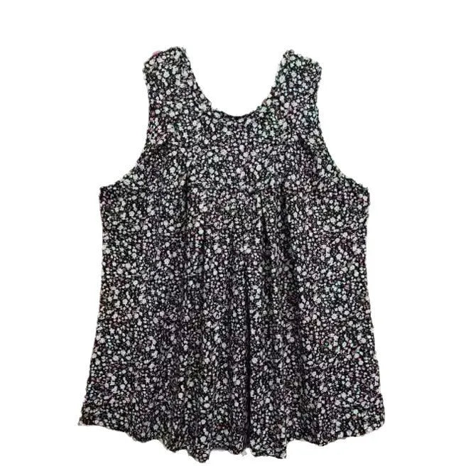 Plus size woman wearing a black floral print sleeveless vest, loose fit.