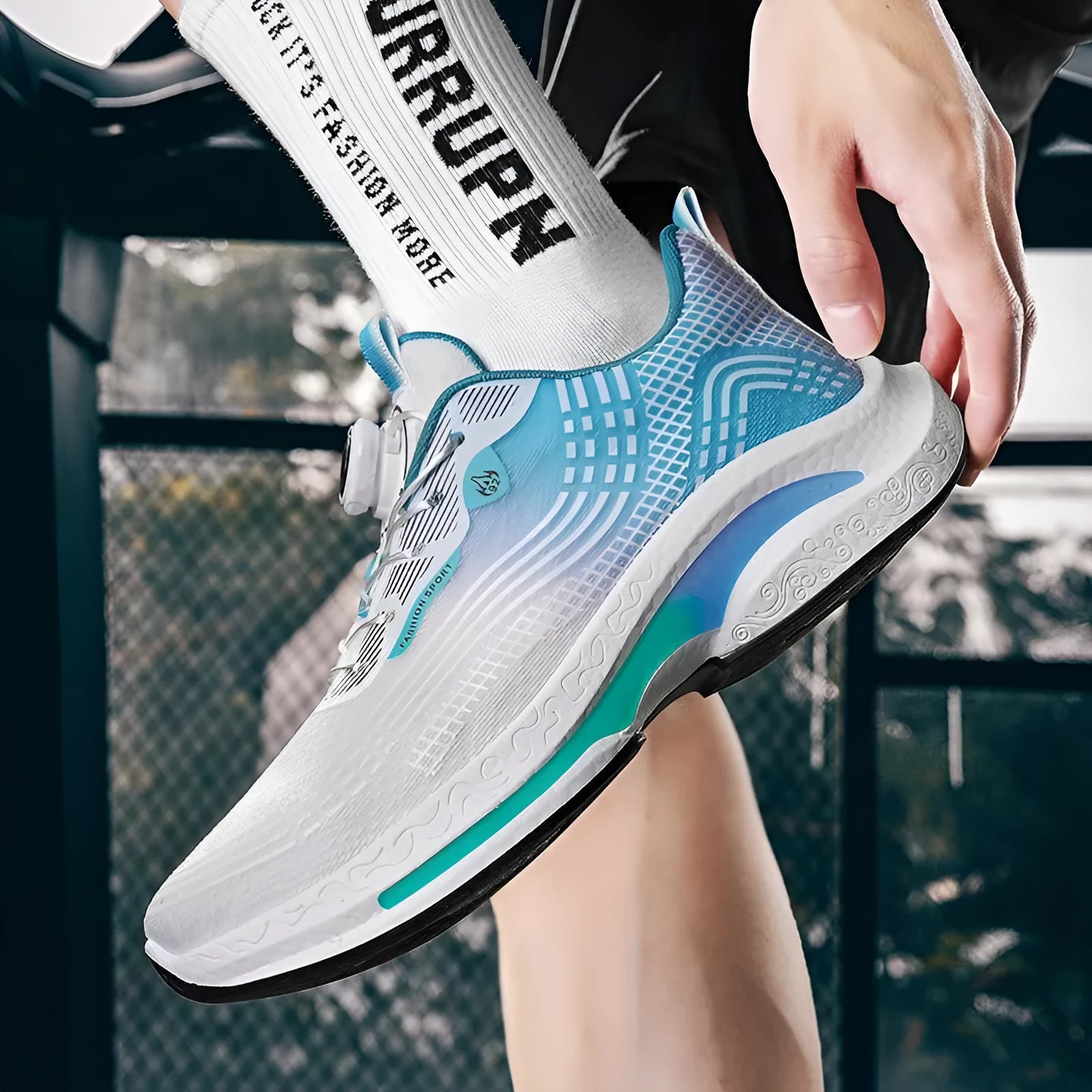 Men's white and blue mesh sneaker with a rotating buckle and rubber sole.
