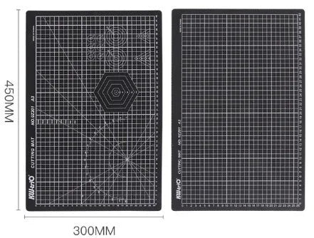 Green A3 self-healing cutting mat with centimetre grid for craft knives on a desk