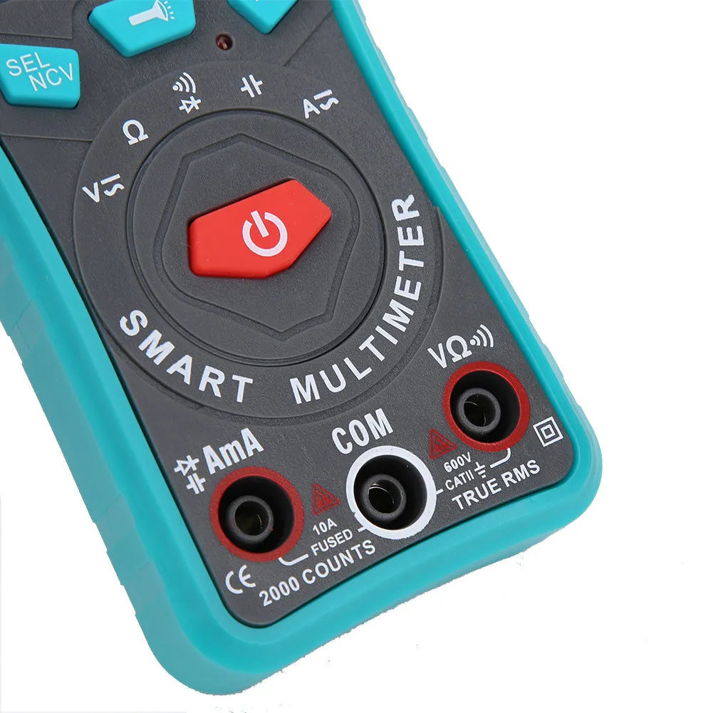 Green universal digital multimeter with automatic ranging and LED display on a table.