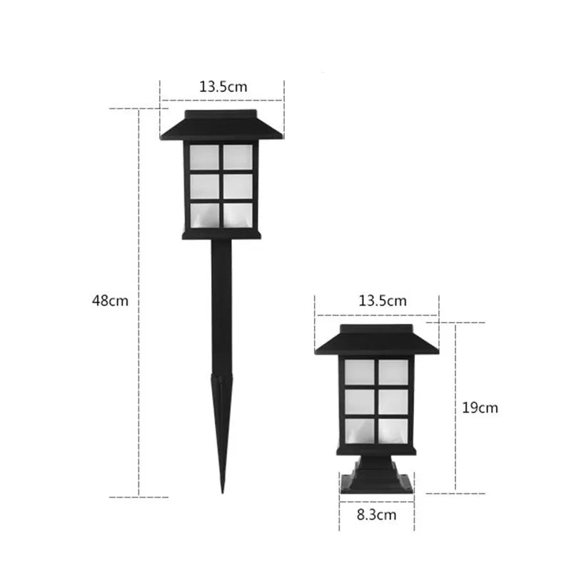 Black solar outdoor LED lawn light with window-style apertures emitting soft white or warm white light