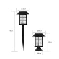 Black solar outdoor LED lawn light with window-style apertures emitting soft white or warm white light