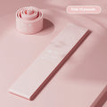 Four plastic resistance bands in pink, orange, beige and green colours showing different tension levels