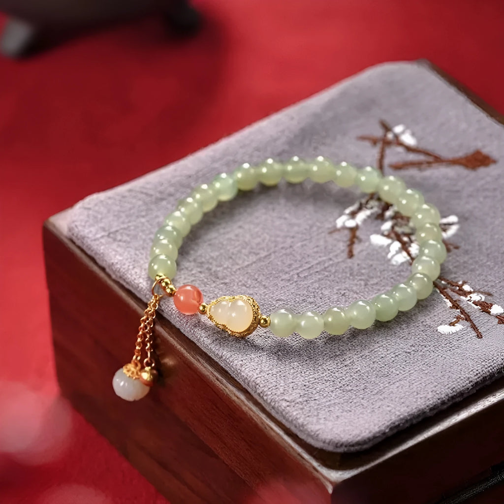 Qingshui jade bracelet with gold plated gourd charm and fu character pendant on adjustable cord