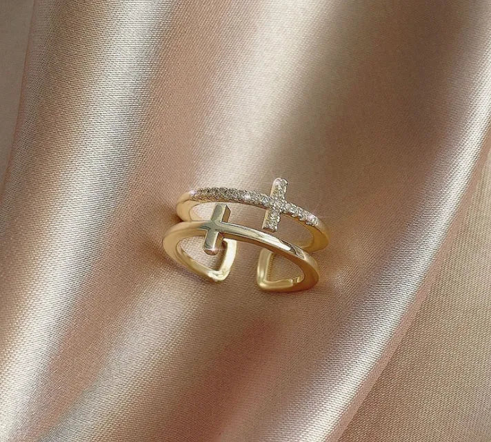Adjustable double cross geometric ring with zircon stones in a white gold colour finish.
