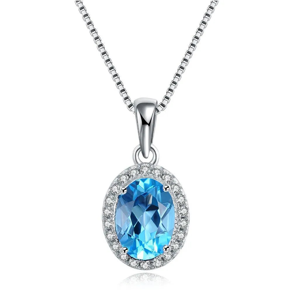 925 sterling silver four-piece jewellery set with blue topaz gems showing geometric-designed earrings, ring, pendant, and necklace