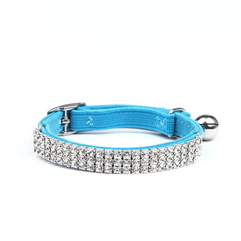 A soft velvet cat collar with a central rhinestone, shown in one of five available colours.