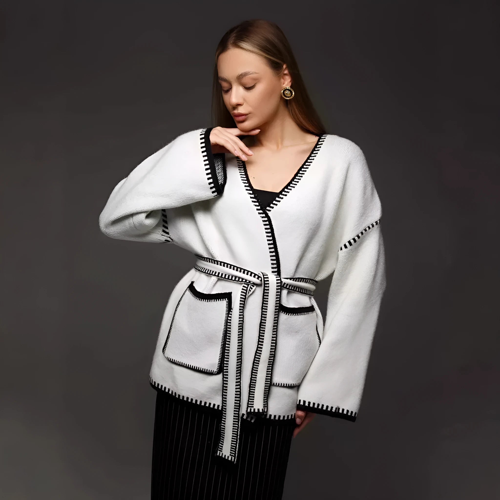 Loose mid-length knitted cardigan with lace-up front, in white, black, or camel.
