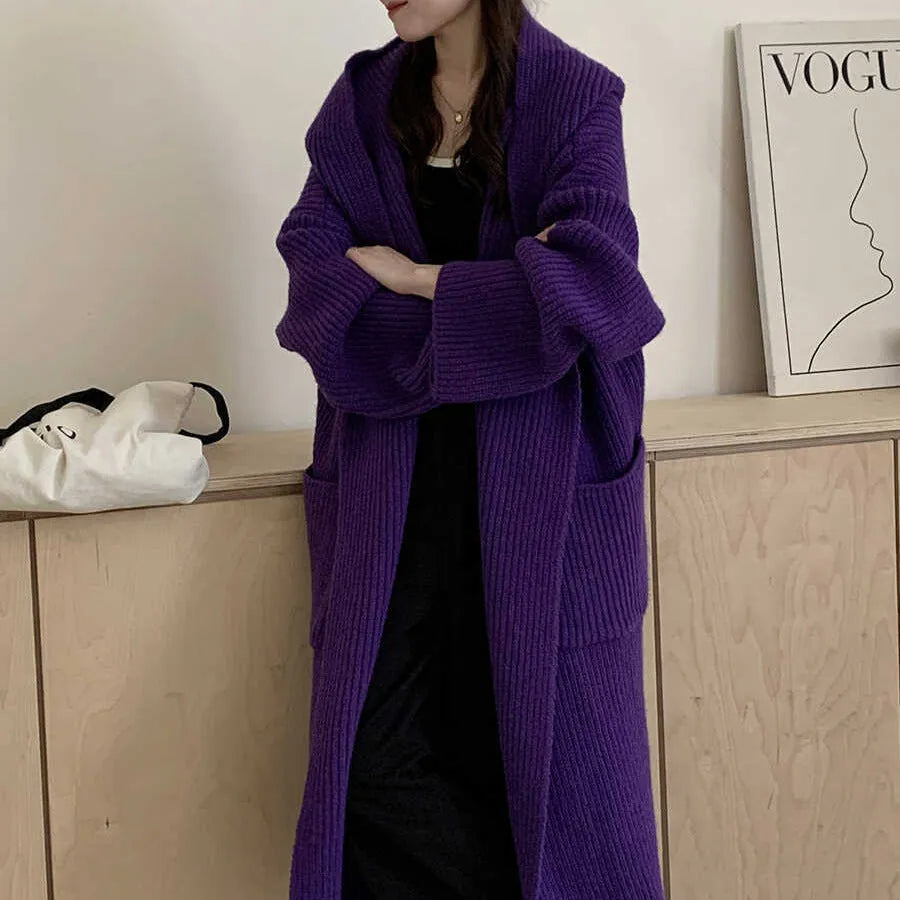 Loose grey hooded cardigan coat with long sleeves on a hanger