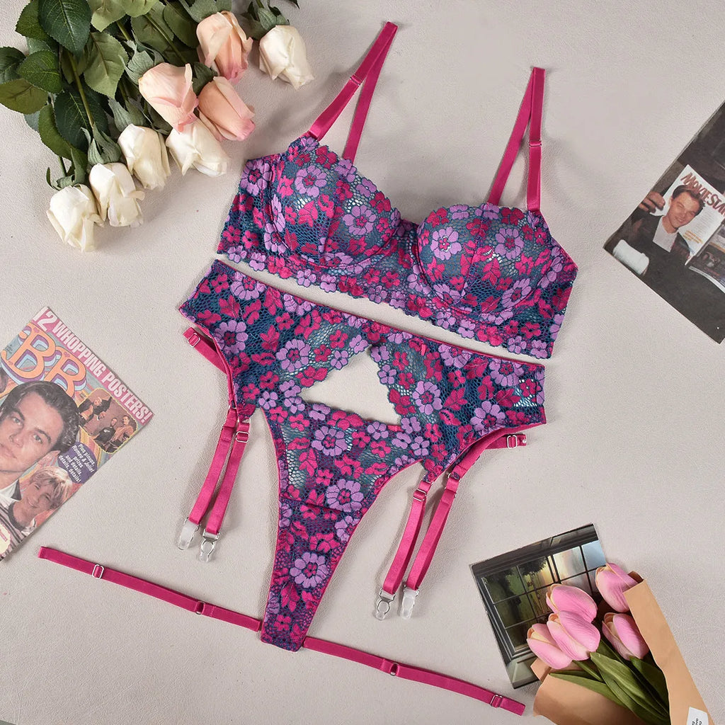 Rose red women's bikini set with floral embroidery on a white background.