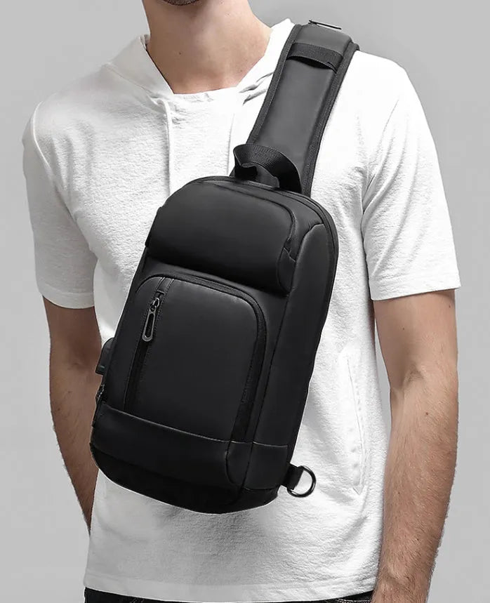 Black PVC outdoor shoulder bag showing internal laptop pocket and air cushion shoulder strap.