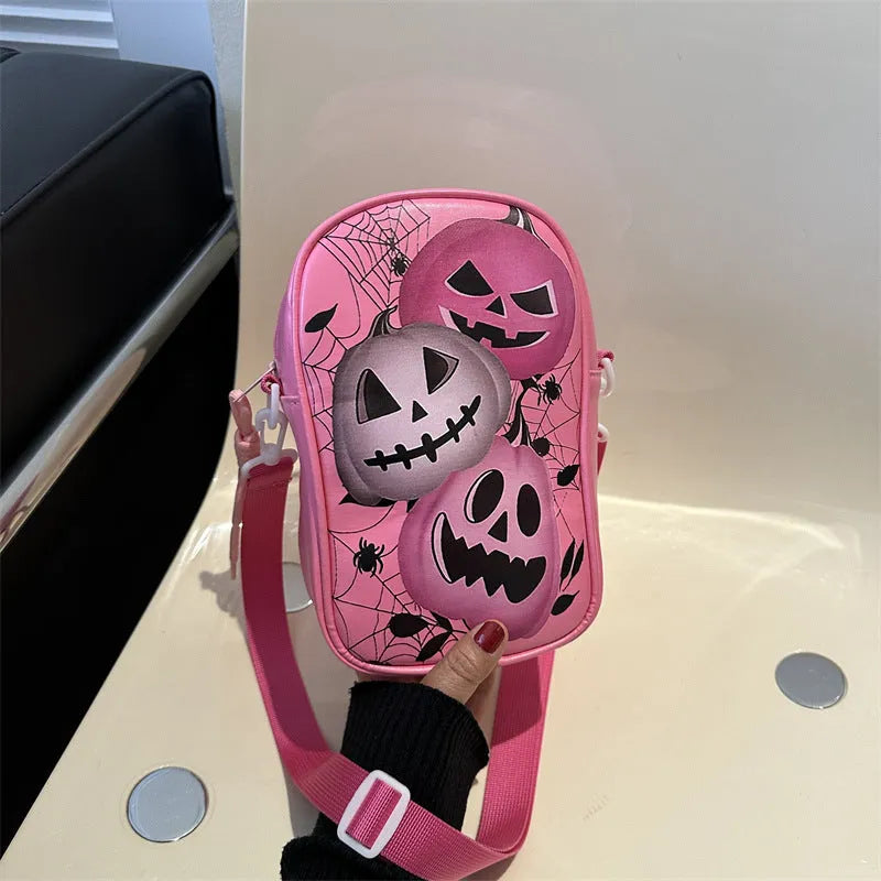 Black Halloween crossbody bag with cartoon pumpkin, ghost, and bat print, showing front and strap.