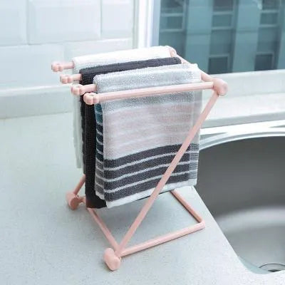Foldable plastic towel shelf with vertical storage in light pink Nordic kitchen organiser
