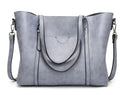 Brown retro women's messenger bag with shoulder strap, showing large main compartment.