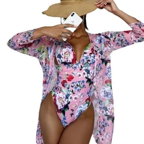 Women's floral patterned tight bikini three-piece swimsuit set with a coat on a hanger.