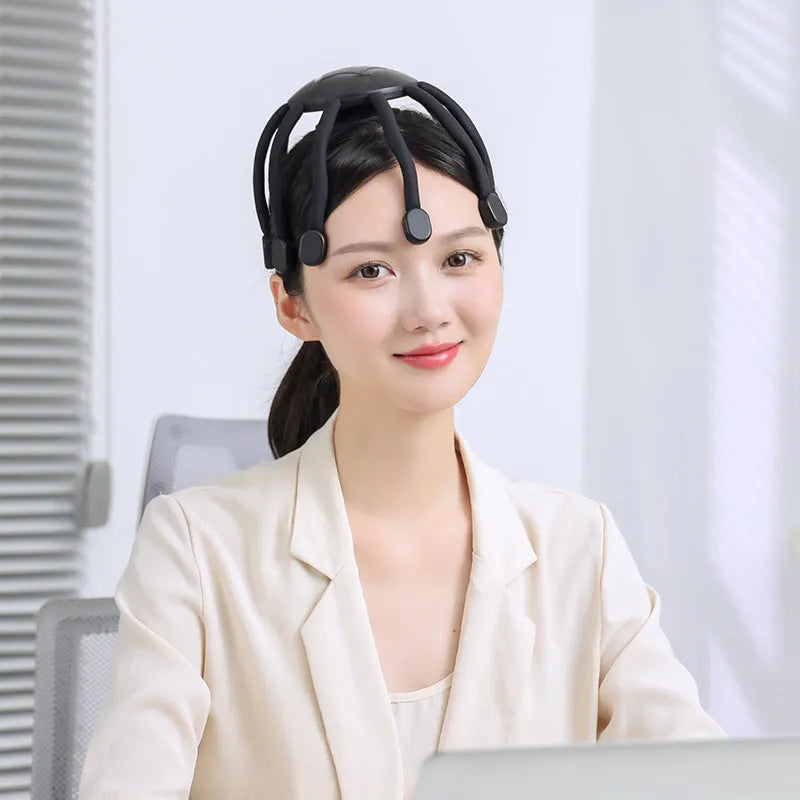 Black and white USB-powered head massagers with multiple vibrating claws for scalp relaxation.