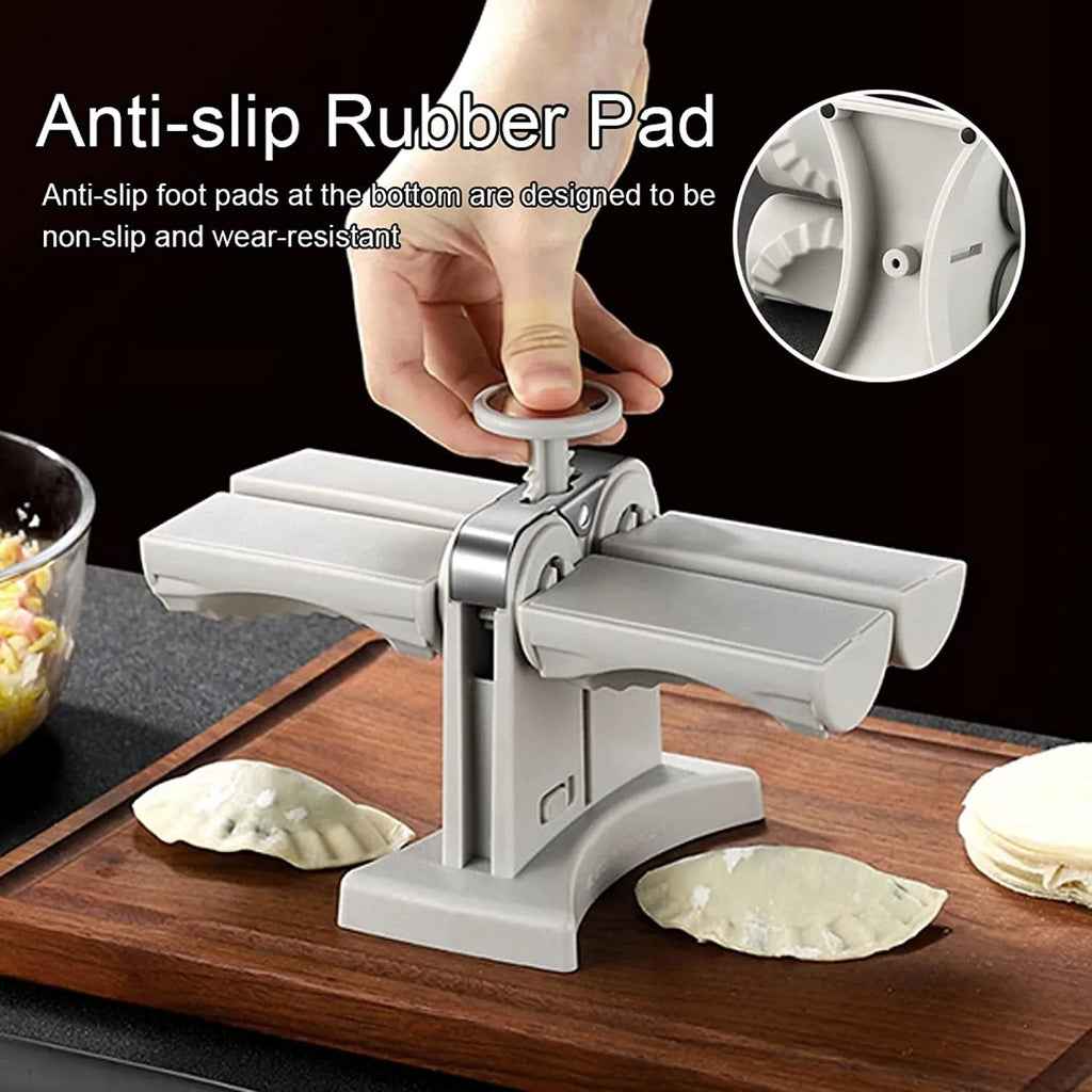 White double-head manual dumpling maker mould made from stainless steel and plastic with an anti-slip base.