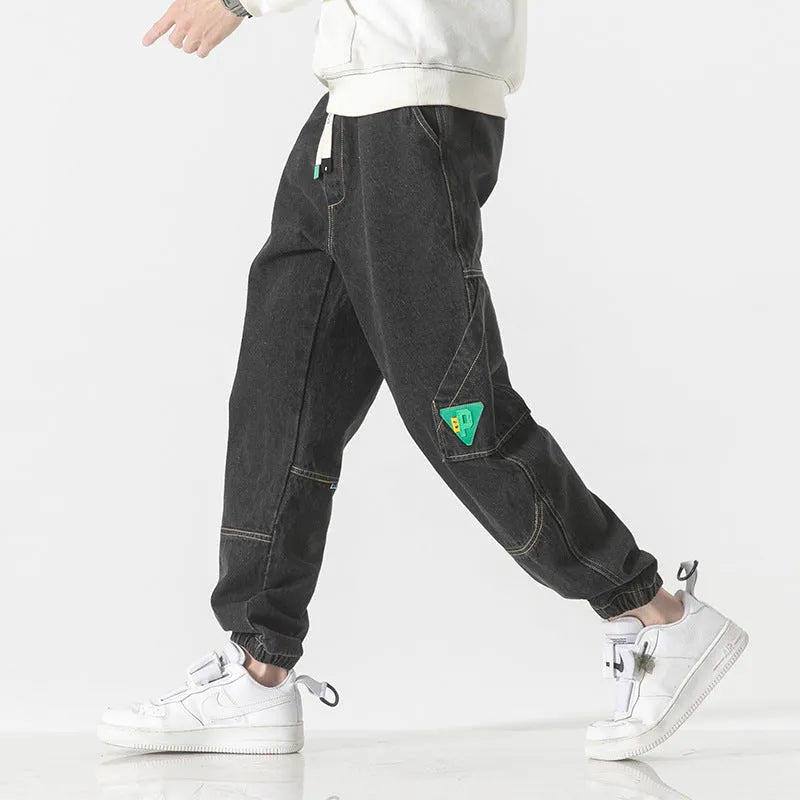Men's loose-fit tapered cotton trousers in black, blue, and grey colours showing mid-waist design