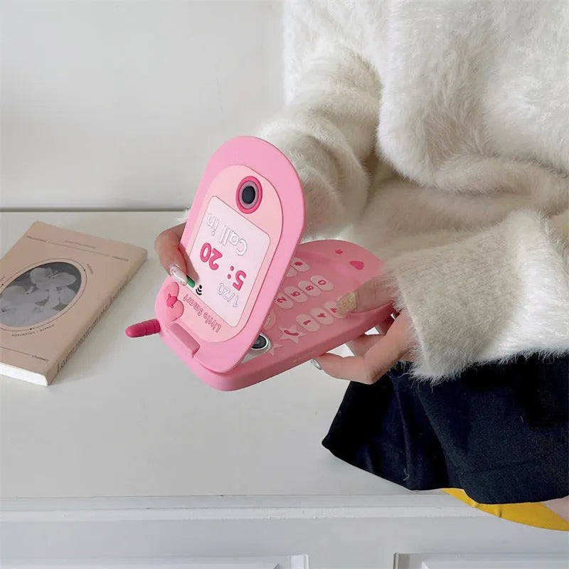 Light pink silicone flip phone case with mirror for iPhone, showing cute cartoon design.