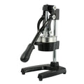 Black cast iron manual citrus juicer with stainless steel cone on a white background