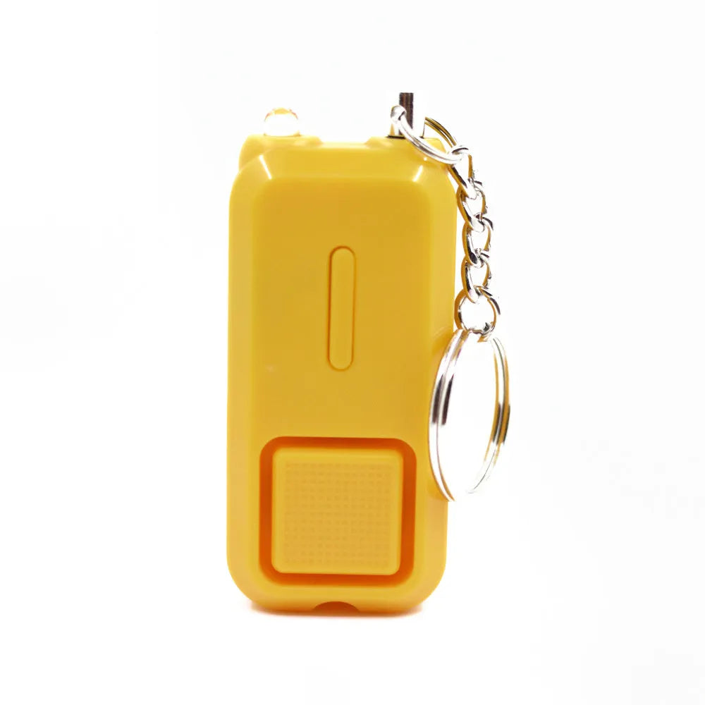 Small pink personal safety alarm on a keyring with a pull-pin activation mechanism.