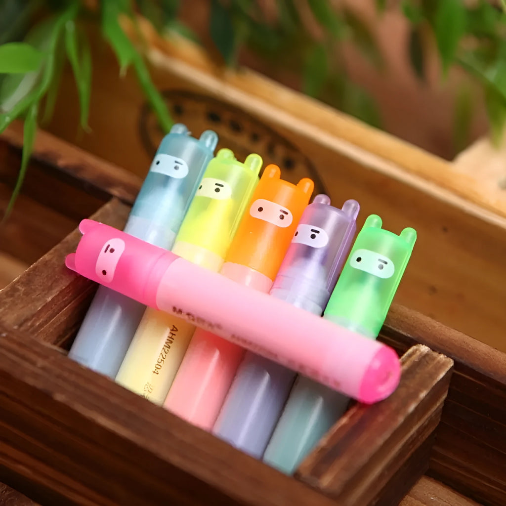 Set of six plastic highlighter pens in different colours with oblique pen shapes