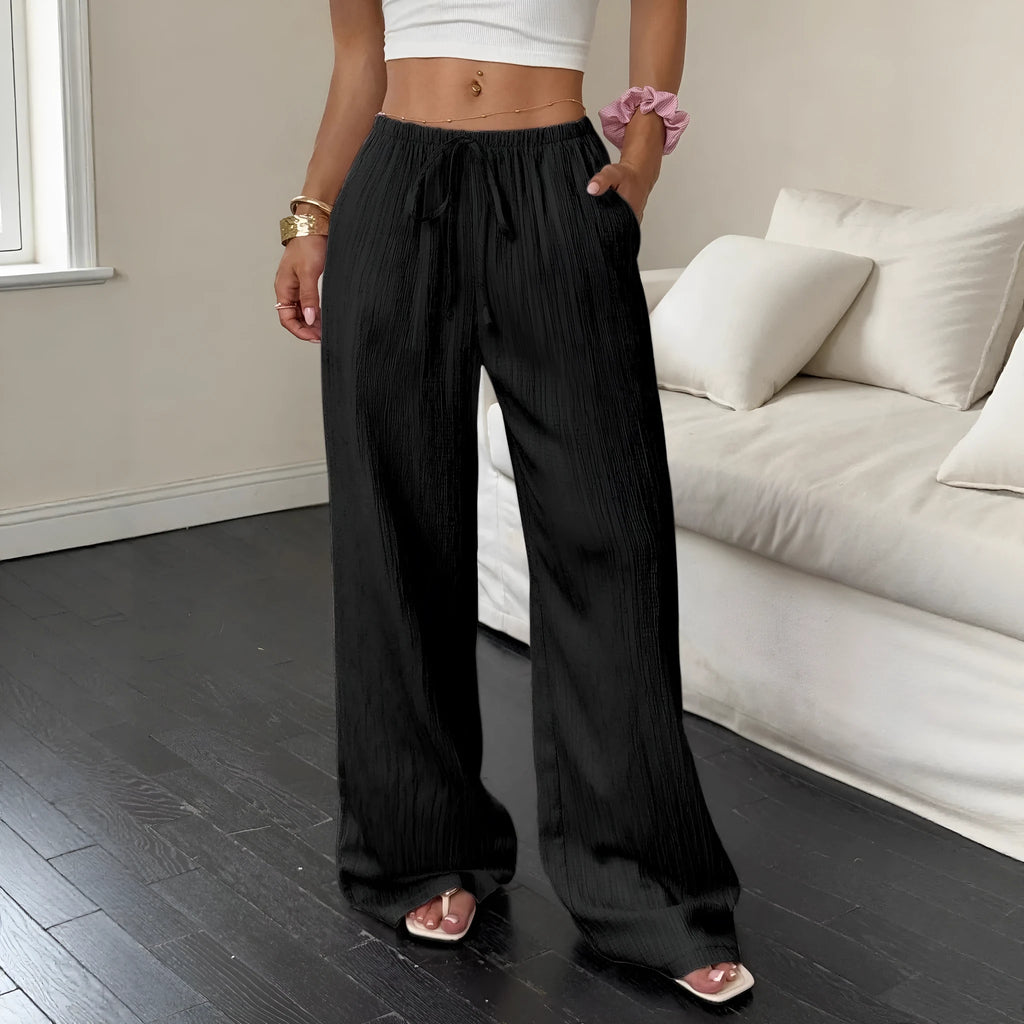 Black wide-leg women's trousers with a lace-up detail on the mid-rise waistband.
