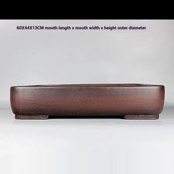 Large rectangular antique purple clay flower pot for indoor plants on a tabletop.