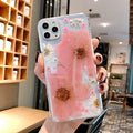 Pink and yellow floral print TPU back cover case for iPhone on a white background