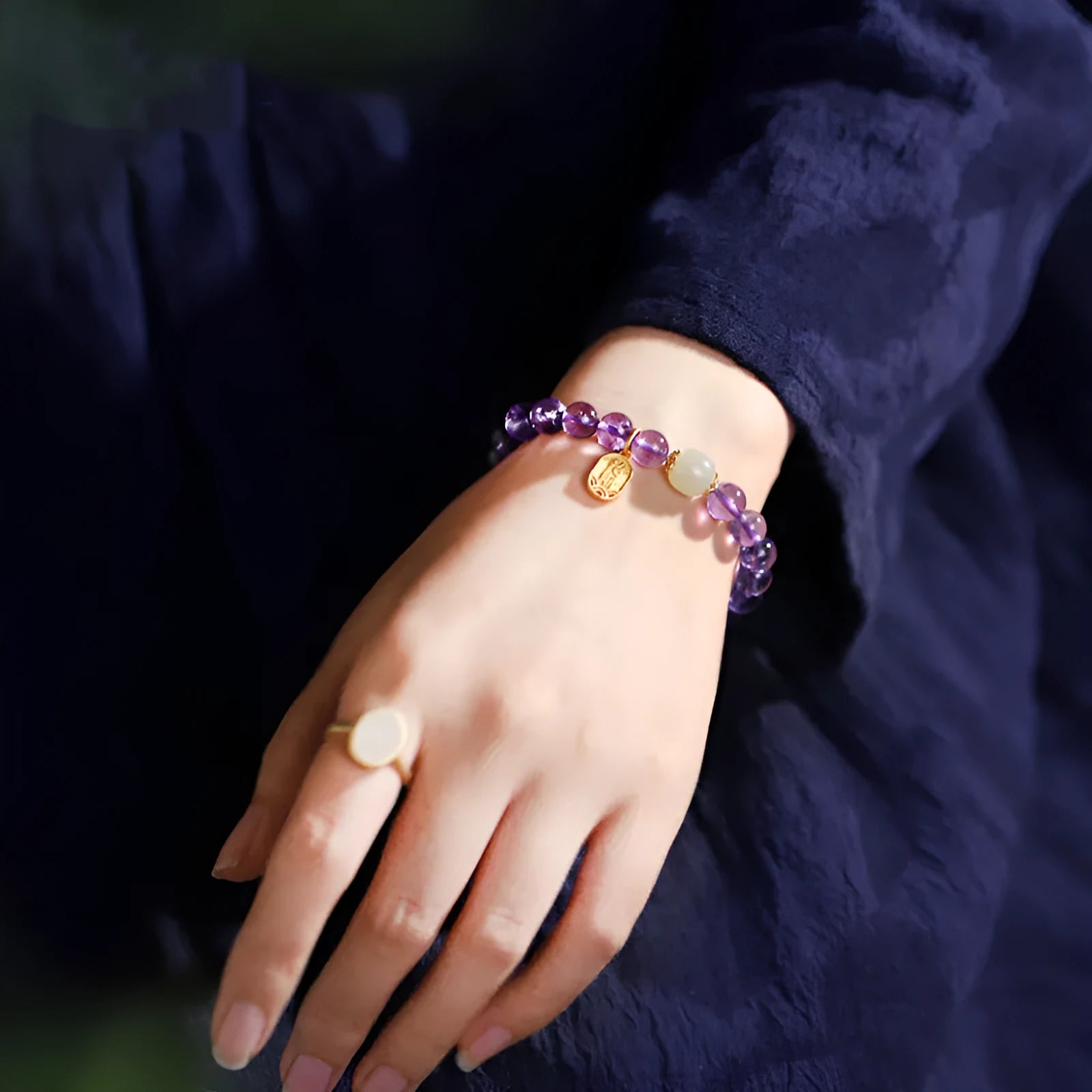 Close-up of a women's bracelet with purple amethyst crystal geometric beads measuring 8mm