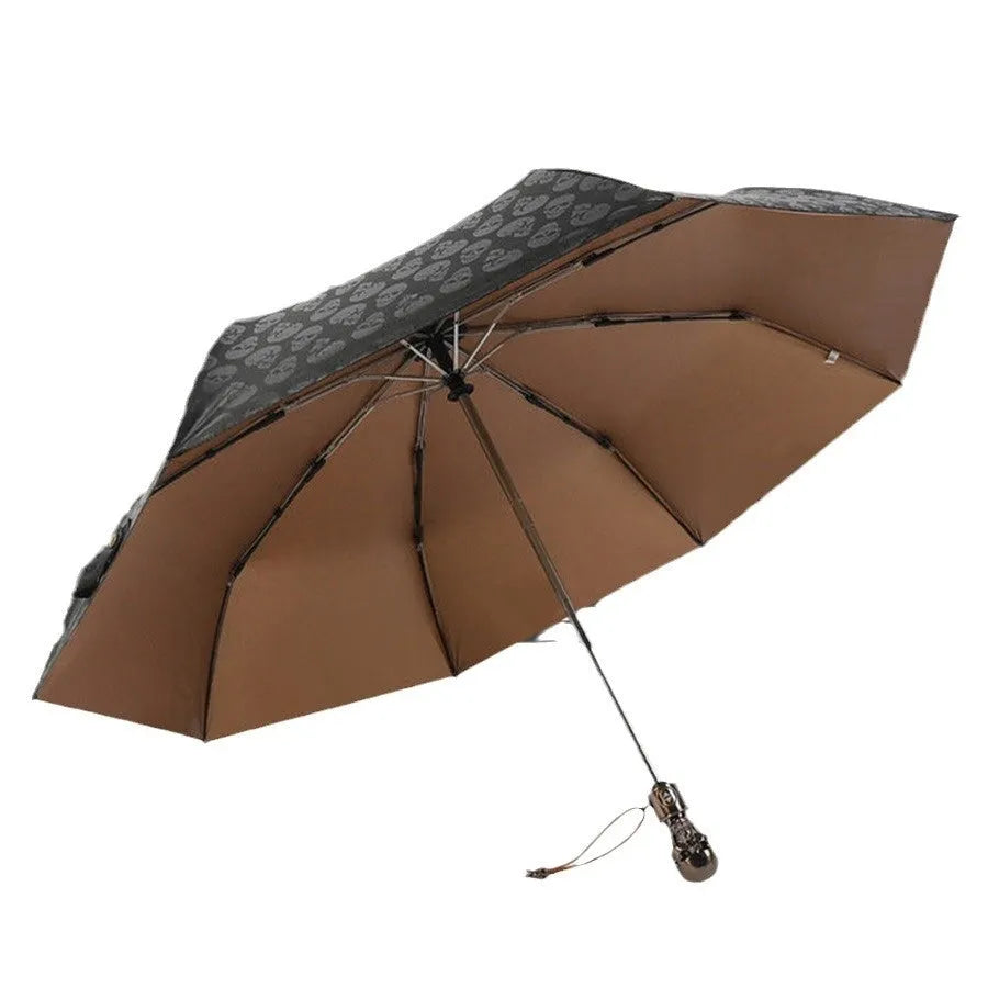 Three-fold automatic skull umbrella with black gold capsules colour, 100cm diameter, and steel handle