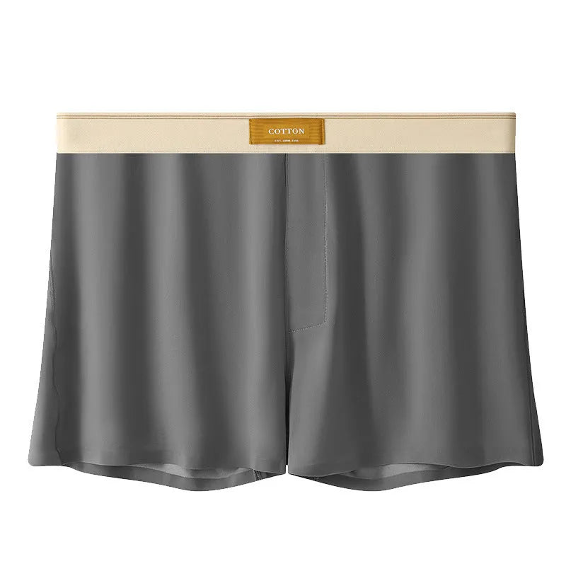 Pack of three men's loose fit ice silk boxer shorts in solid colours on a mid-waist model.