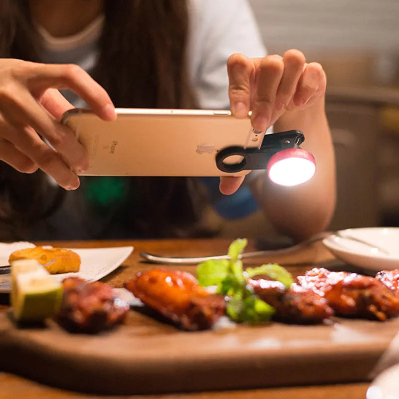 External clip-on mobile phone camera lens with wide-angle lens and colourful LED ring light.