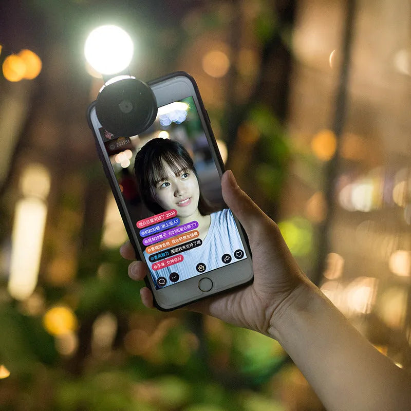 External clip-on mobile phone camera lens with wide-angle lens and colourful LED ring light.