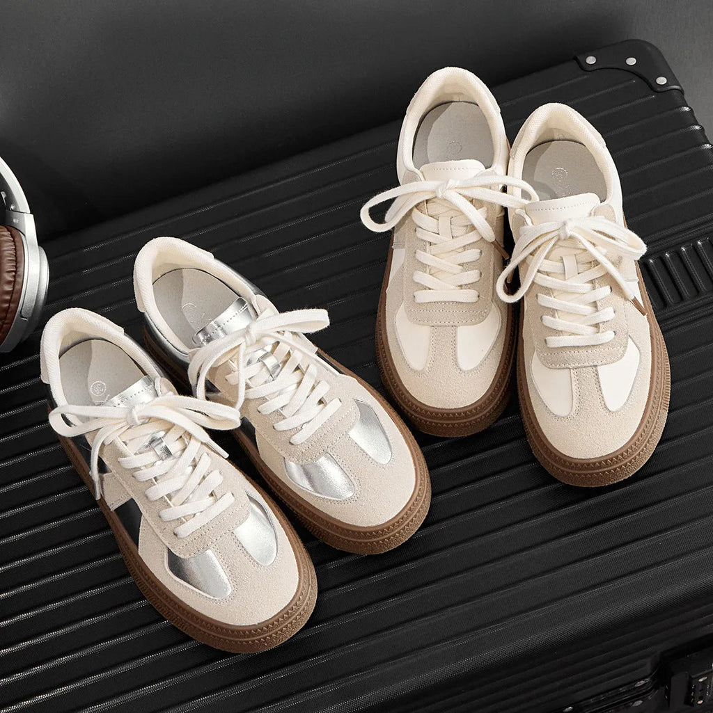 Retro sports board shoes with cross shoulder straps in milky white colour showing round toe and lace-up design