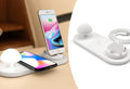 White 3 in 1 wireless charging dock with a phone on the pad and USB cable
