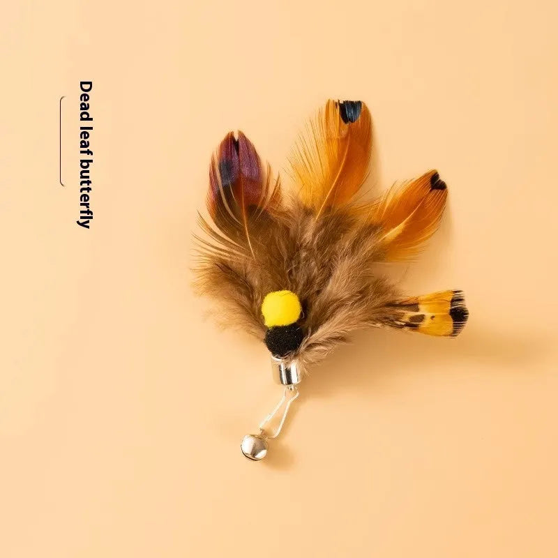 Three steel wire cat toys shaped like small flying insects on a plain background.