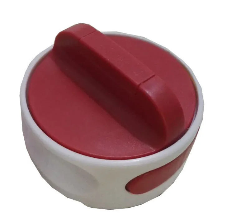 Green stainless steel bottle opener gadget for screw-top lids on a kitchen counter.