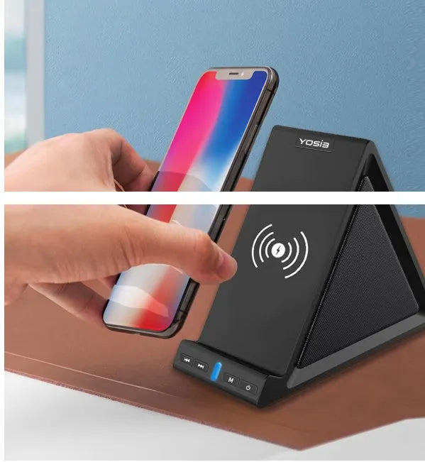 Black Bluetooth speaker with built-in stand holding a mobile phone on a desk.