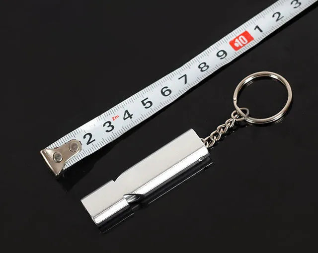 Silver or gold coloured aluminium alloy double hole outdoor survival whistle.