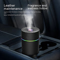 Black and white USB car mini humidifier with aromatherapy function on a car dashboard.