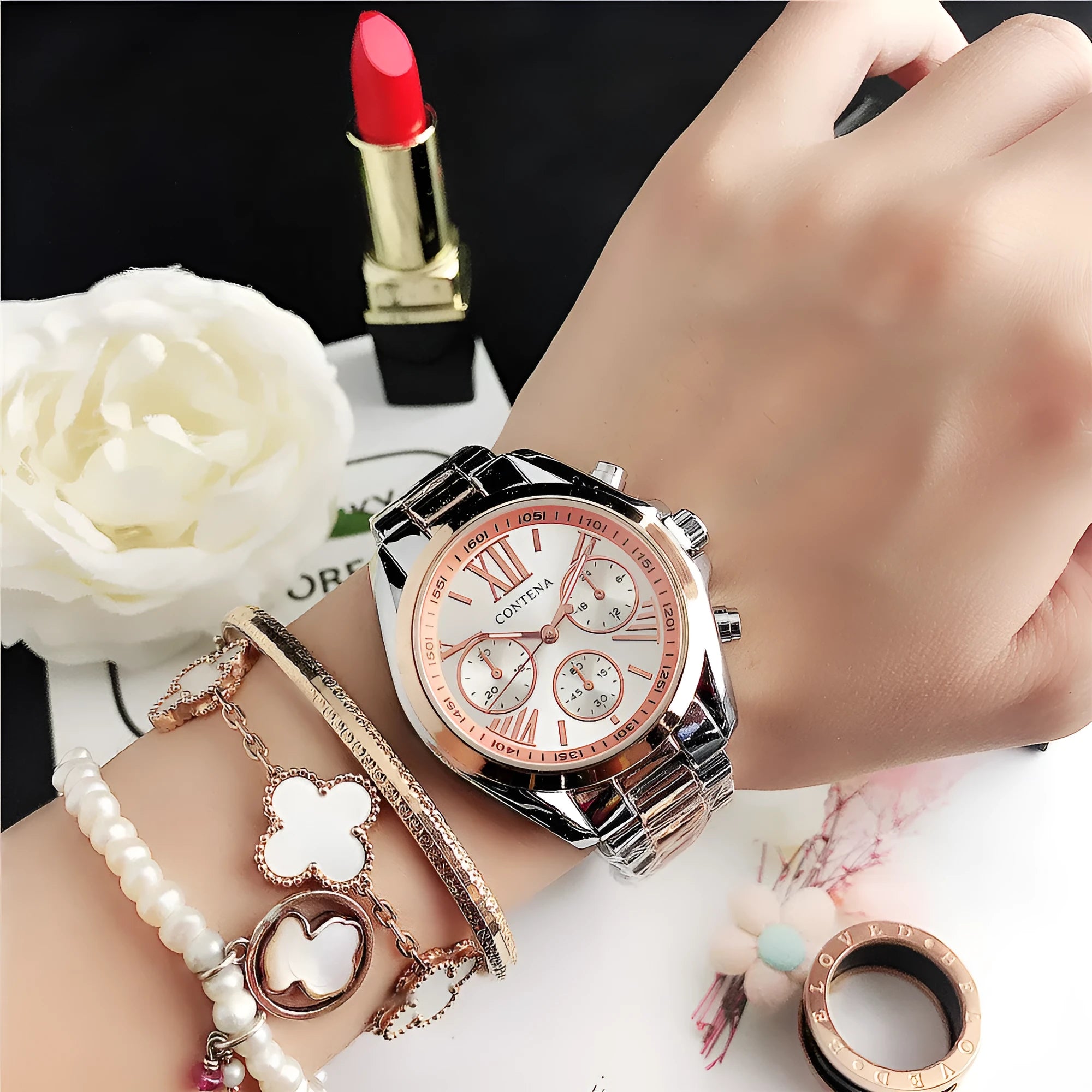 Women's silver and rose gold quartz watch with mesh strap and pointer display.