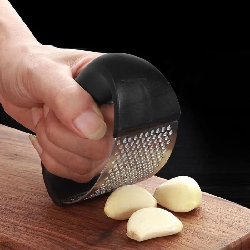Stainless steel garlic press with non-slip handle in available colours crushing garlic